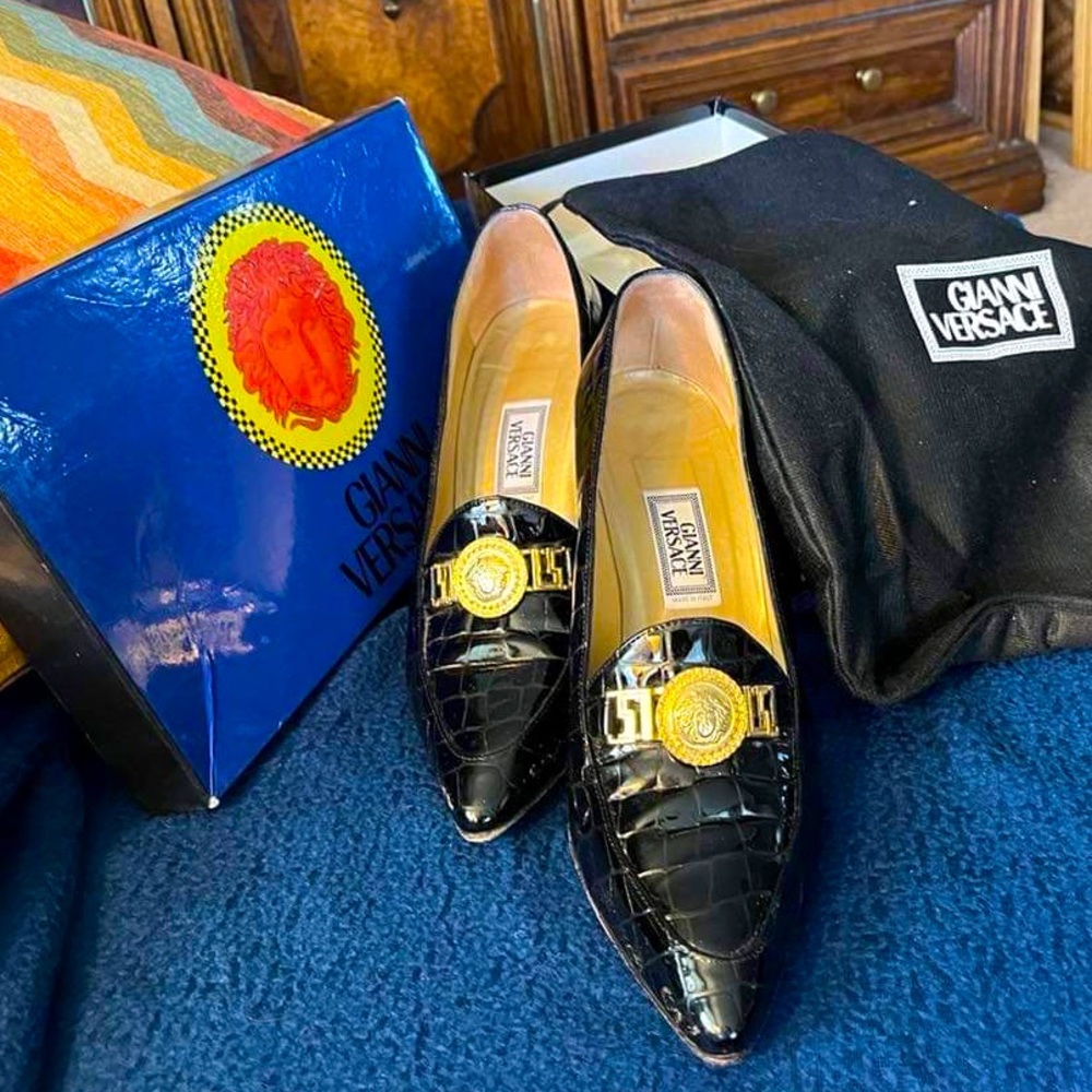 Black patent leather pumps with gold Versace medallion on top